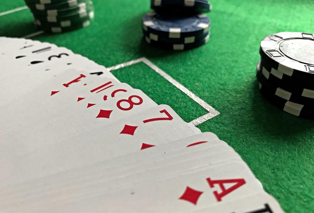 Kartu remi dan susunan chip poker di atas meja